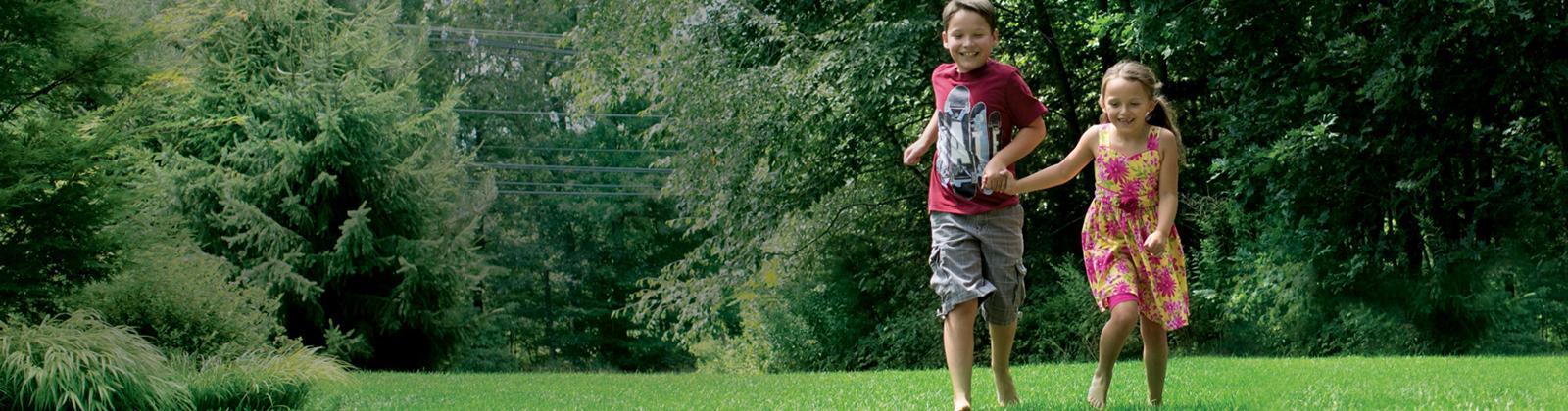 Children enjoy a mosquito-free lawn after NaturaLawn's family-safe mosquito lawn treatment